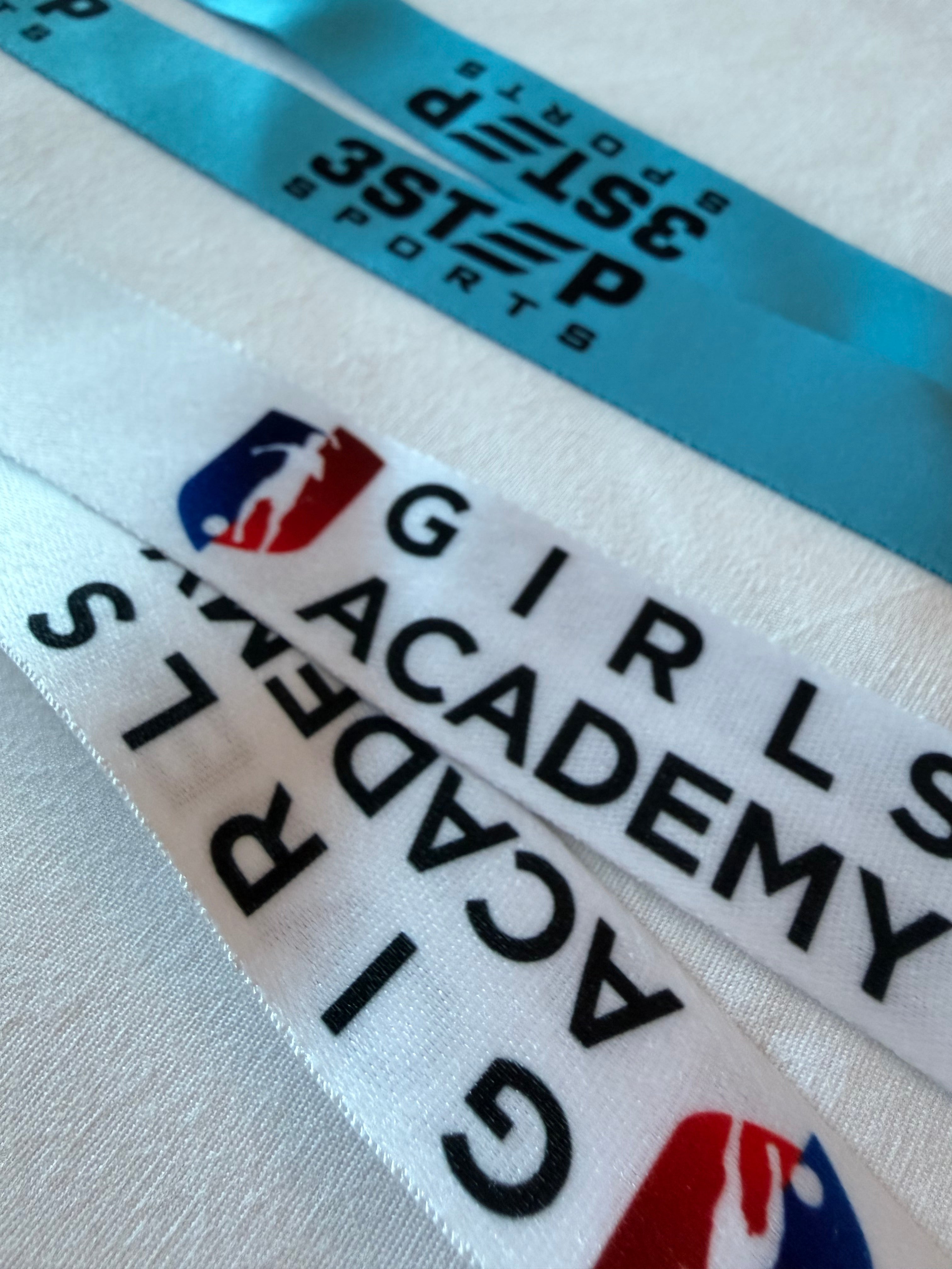 Custom-imprinted lanyard with client logo next to a plain stock lanyard